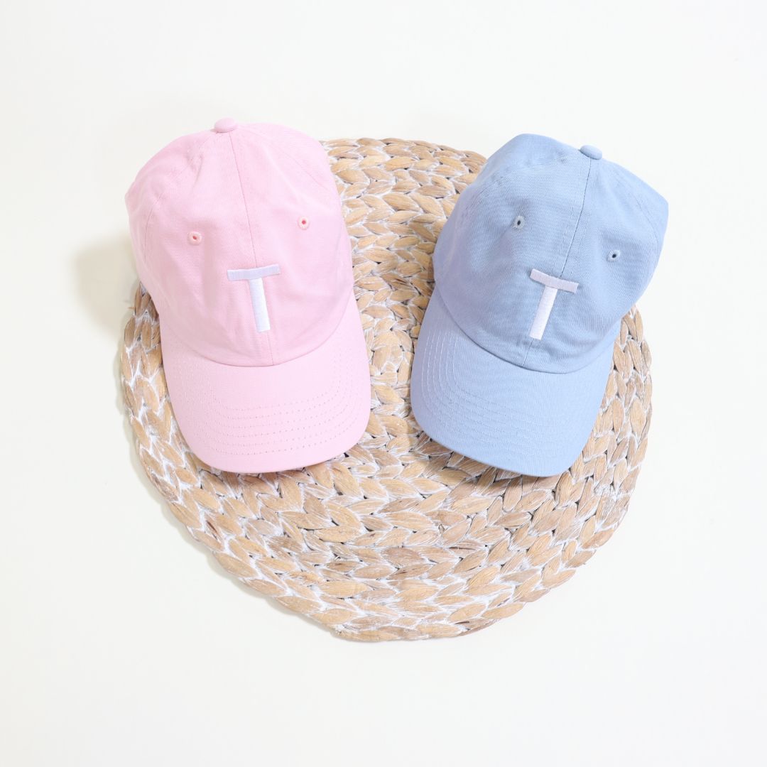 Personalized embroidered kids hats in baby blue and light pink