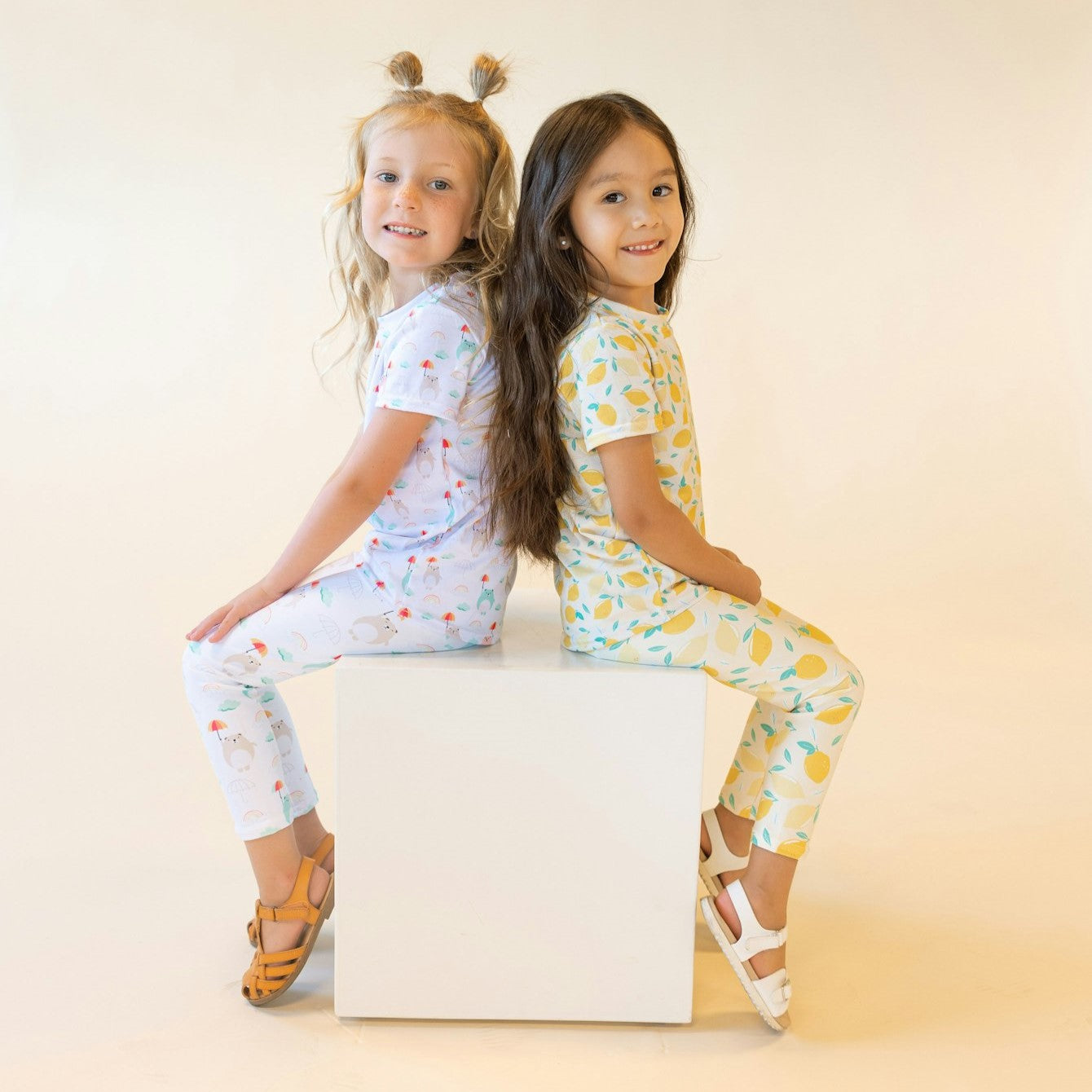 two girls wearing fun and cute set with lemons and bears