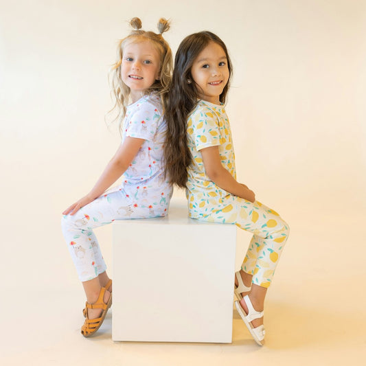 two girls wearing sets with lemon design and bear design 