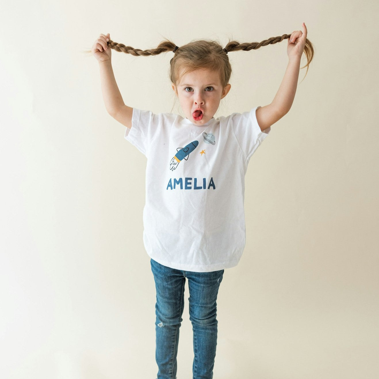 Girl wearing a personalized kids shirt with space design