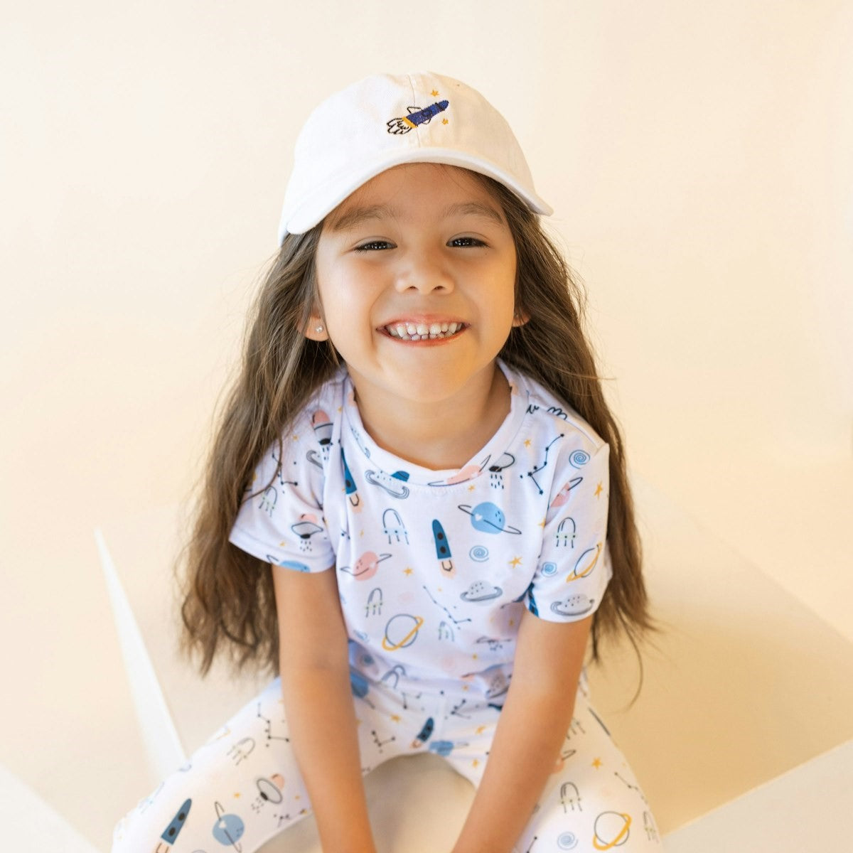 cute girl wearing the rocket ship hat and matching set